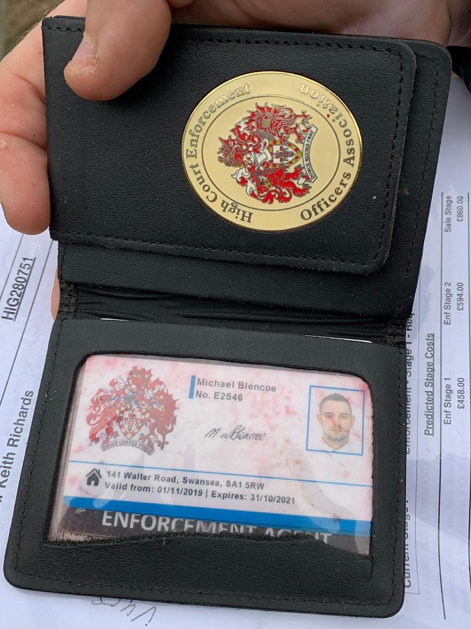 Bailiff carrying a fake police-like warrant card and badge